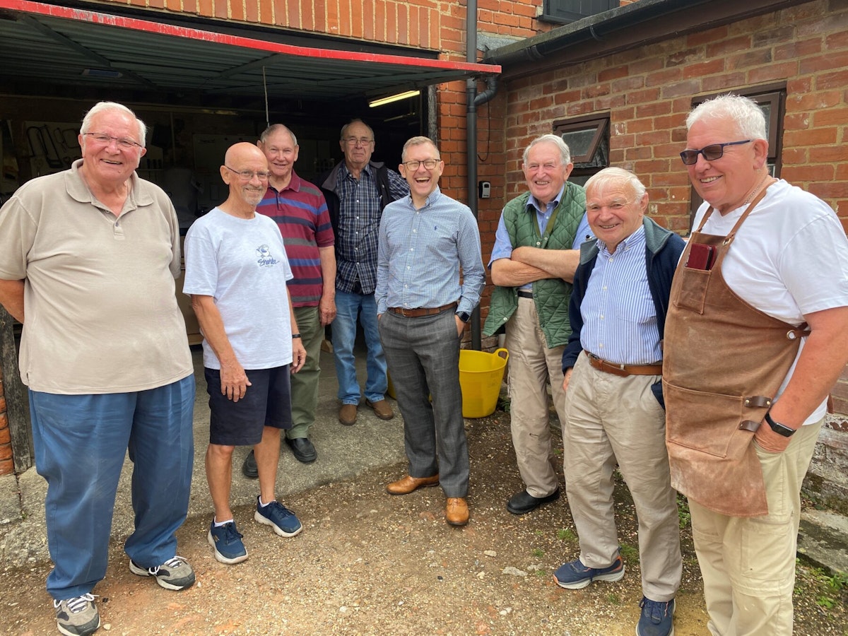 A group of men outside a Mens Shed